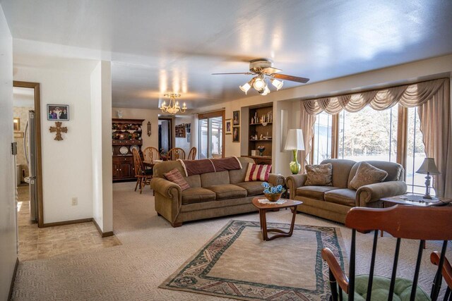 W5384 25th St, Necedah, WI 54646 - living room with light carpet, ceiling fan with notable chandelier, and baseboards