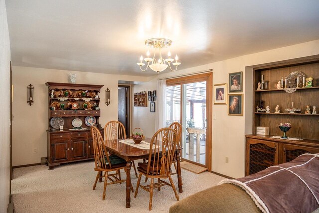 W5384 25th St, Necedah, WI 54646 - dining area featuring light carpet, a notable chandelier, and baseboards