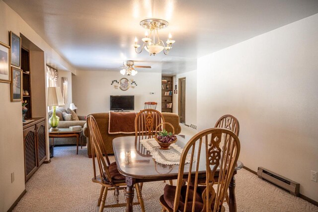 W5384 25th St, Necedah, WI 54646 - dining area with a baseboard radiator, light colored carpet, and ceiling fan with notable chandelier