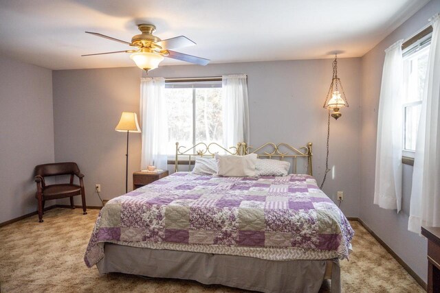 W5384 25th St, Necedah, WI 54646 - bedroom with light colored carpet, ceiling fan, and baseboards