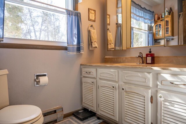 W5384 25th St, Necedah, WI 54646 - half bath featuring toilet, vanity, and baseboard heating