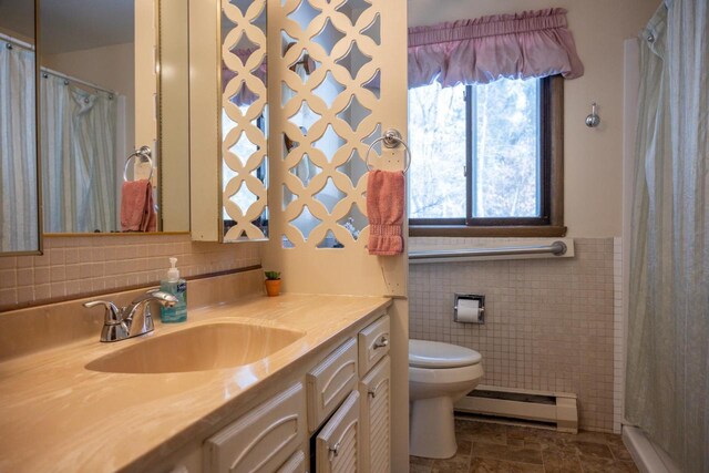 W5384 25th St, Necedah, WI 54646 - bathroom with baseboard heating, toilet, vanity, and tile walls