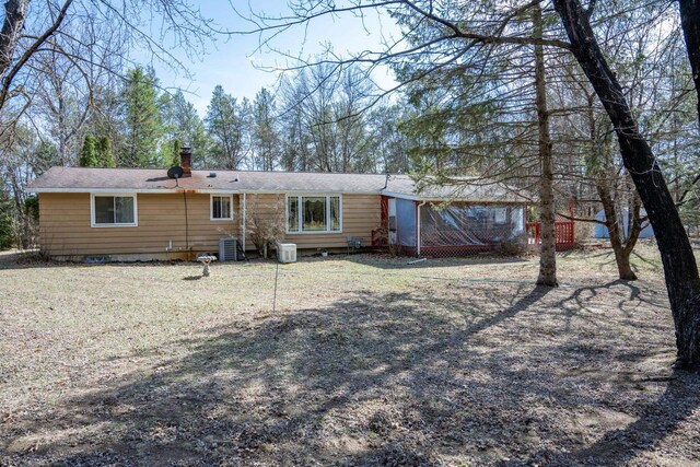 W5384 25th St, Necedah, WI 54646 - back of house featuring central air condition unit and a chimney
