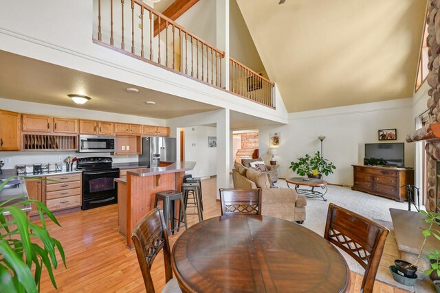 29323 Riverview Ln, Waterford, WI 53185 - dining space featuring light wood-style flooring and high vaulted ceiling