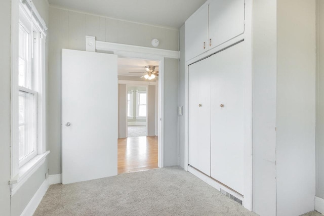 interior space with visible vents and light colored carpet