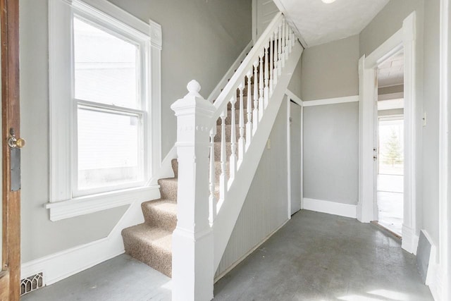 stairway with concrete floors and visible vents