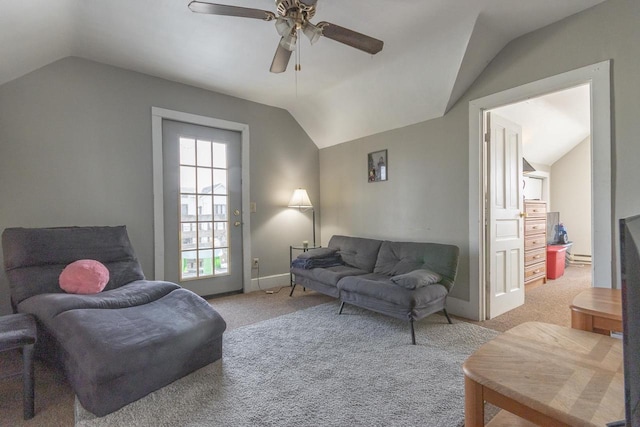 living room featuring ceiling fan, light colored carpet, baseboards, and lofted ceiling