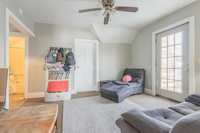 sitting room with carpet floors, ceiling fan, vaulted ceiling, and baseboards