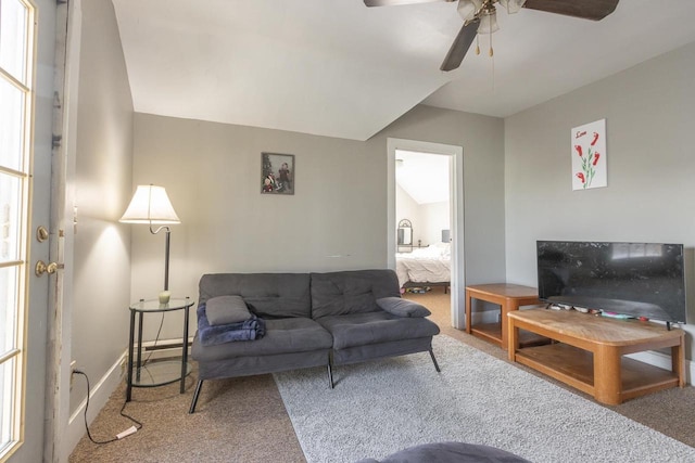living room with a ceiling fan and carpet floors