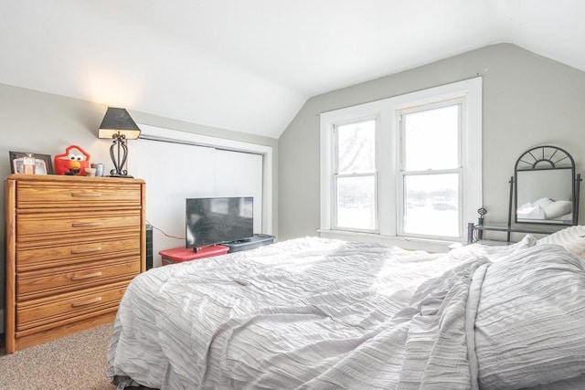 carpeted bedroom featuring vaulted ceiling
