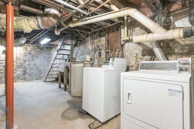 clothes washing area with laundry area and washer and clothes dryer