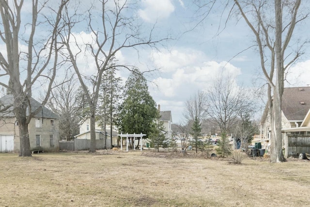 view of yard featuring fence and a residential view