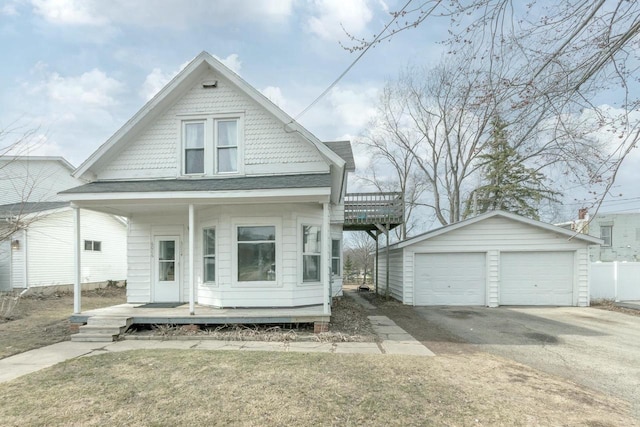 shotgun-style home with an outdoor structure and a detached garage
