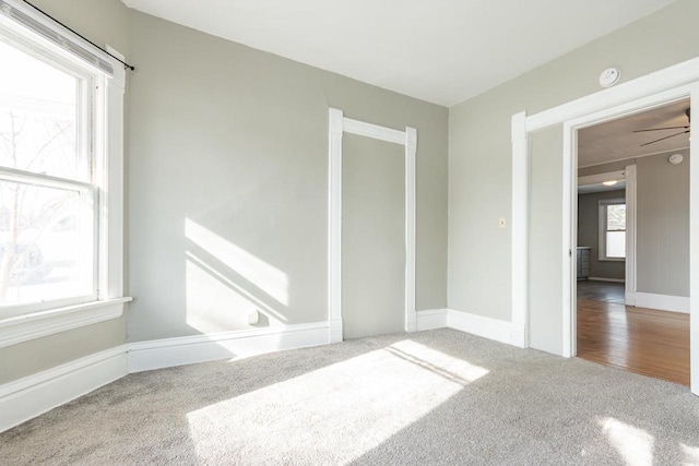 unfurnished room featuring baseboards and carpet