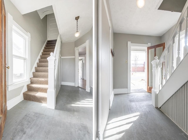 foyer entrance featuring baseboards and stairs