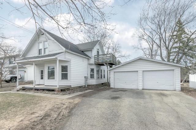view of home's exterior with an outbuilding, a garage, and a balcony