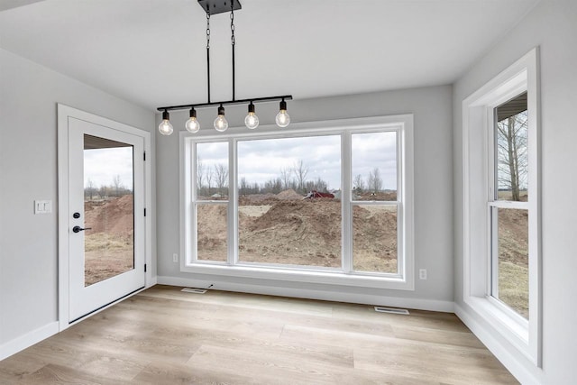 1377 Shelby Ln, De Pere, WI 54115 - unfurnished dining area with visible vents, baseboards, and light wood-style flooring