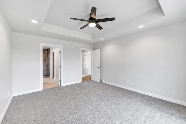 1377 Shelby Ln, De Pere, WI 54115 - unfurnished bedroom featuring a tray ceiling, light colored carpet, baseboards, and recessed lighting