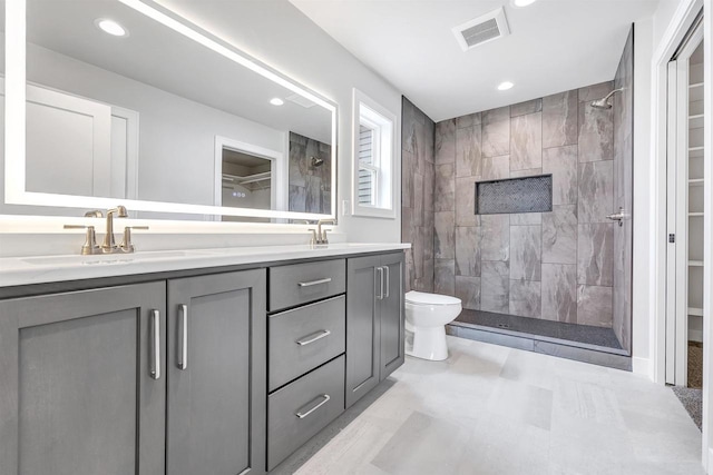 1377 Shelby Ln, De Pere, WI 54115 - full bathroom with tiled shower, double vanity, visible vents, and a sink
