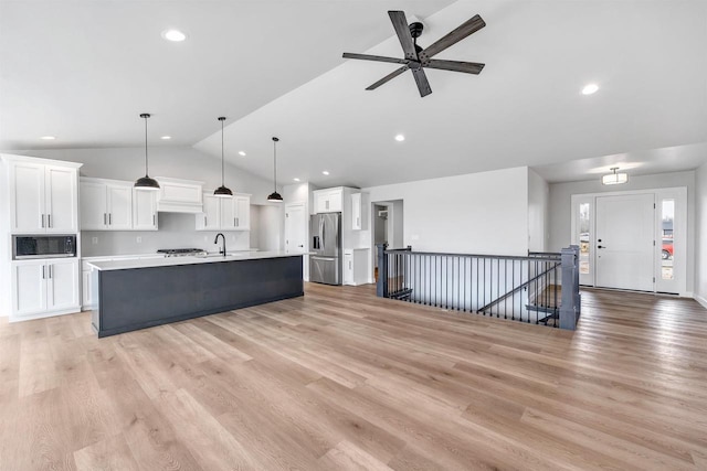 1377 Shelby Ln, De Pere, WI 54115 - kitchen featuring a large island, white cabinetry, stainless steel refrigerator with ice dispenser, built in microwave, and lofted ceiling