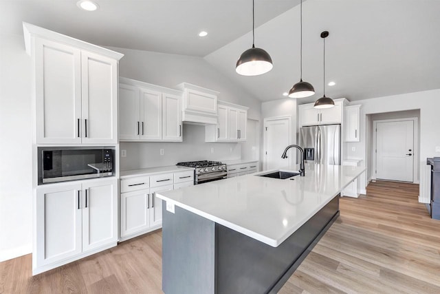 1377 Shelby Ln, De Pere, WI 54115 - kitchen featuring a sink, white cabinetry, vaulted ceiling, and stainless steel appliances