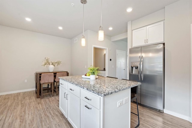 kitchen with white cabinetry, a kitchen island, light wood-style flooring, and stainless steel fridge with ice dispenser