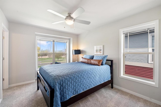 bedroom with a ceiling fan, carpet flooring, and baseboards