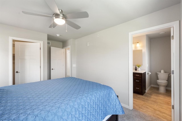 bedroom featuring baseboards, visible vents, ceiling fan, and ensuite bathroom