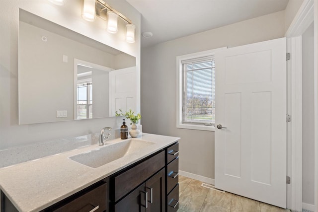 bathroom featuring tile patterned floors, visible vents, vanity, and baseboards