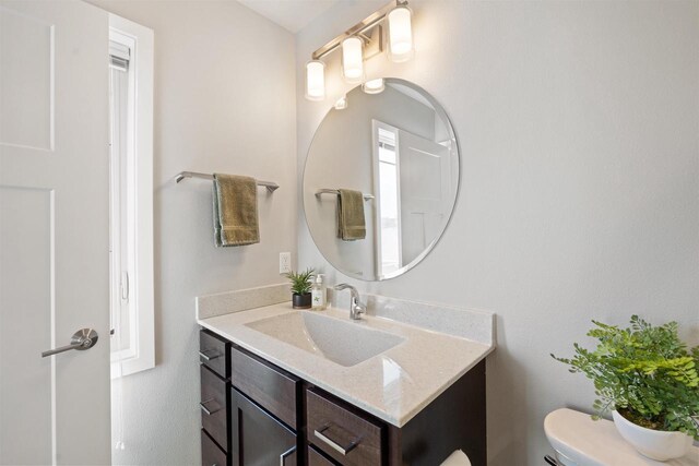 bathroom featuring toilet and vanity