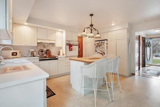 4530 Bleser Ct, Manitowoc, WI 54220 - kitchen featuring light countertops, a sink, white appliances, and recessed lighting