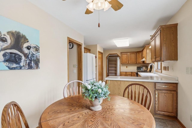 dining area featuring light tile patterned floors and ceiling fan
