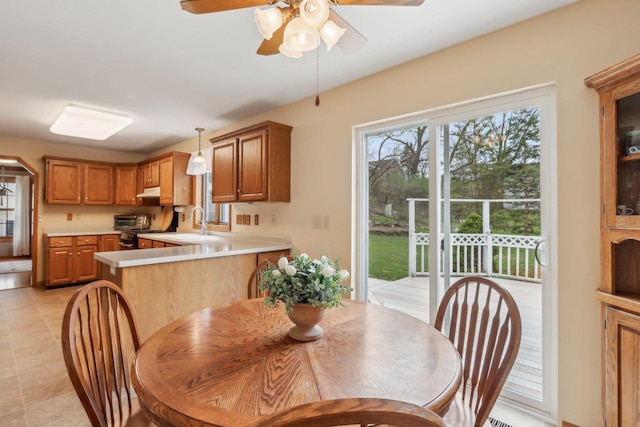 dining room featuring light tile patterned flooring, a toaster, and a ceiling fan