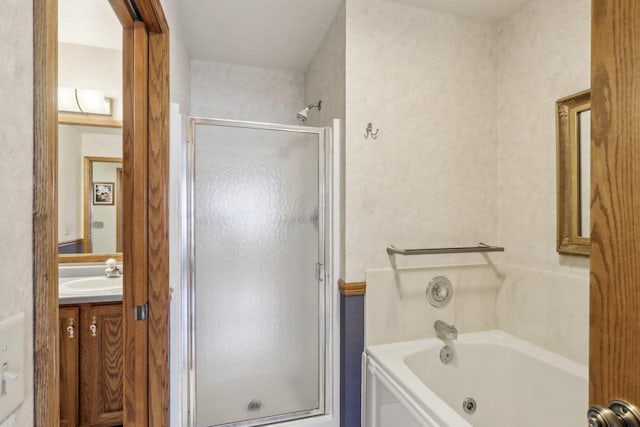 bathroom with vanity, a whirlpool tub, and a stall shower