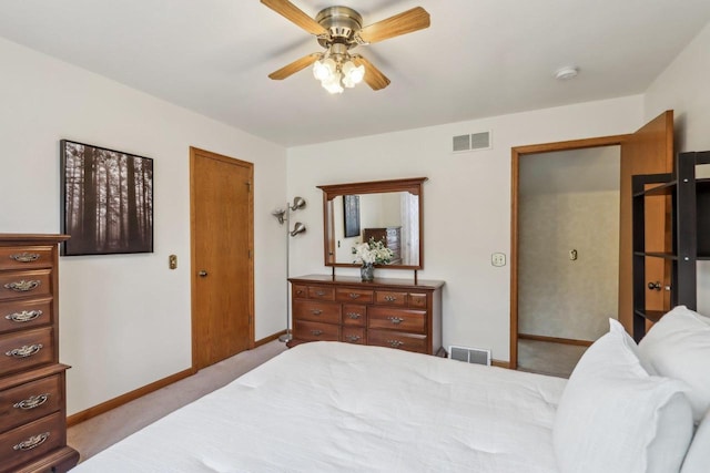 carpeted bedroom with visible vents, ceiling fan, and baseboards