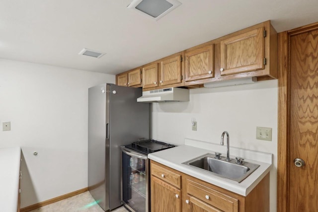 kitchen with a sink, stainless steel electric range oven, light countertops, and under cabinet range hood