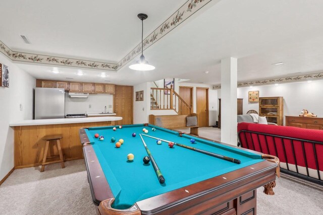 recreation room featuring light carpet, billiards, a sink, baseboards, and indoor bar