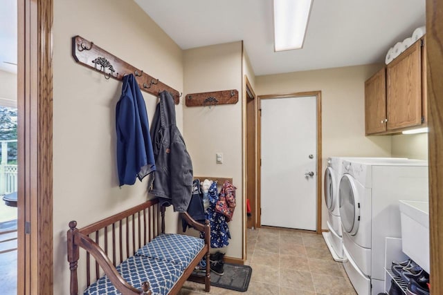 laundry room with cabinet space and washing machine and clothes dryer