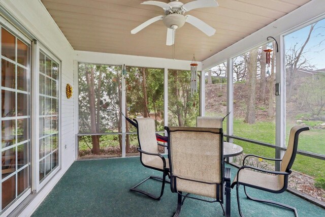 sunroom featuring outdoor dining space and ceiling fan