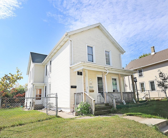 view of front of home with fence, a front lawn, and covered porch