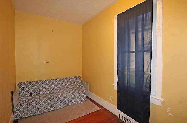 living area featuring wood finished floors and baseboards