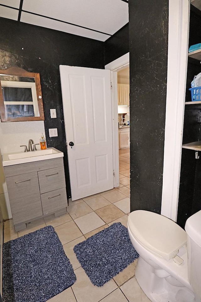 bathroom featuring tile patterned floors, vanity, and toilet