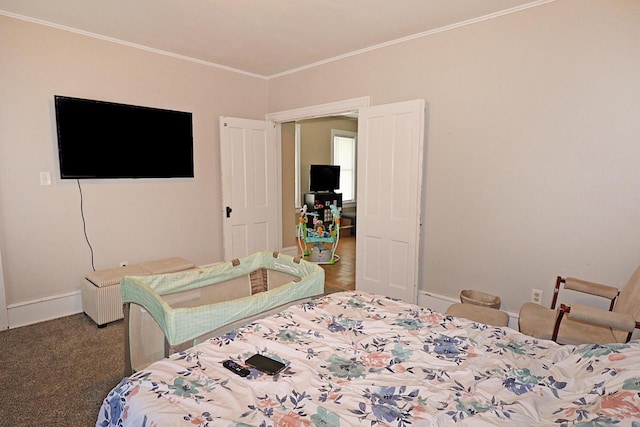 bedroom with crown molding, carpet flooring, and baseboards