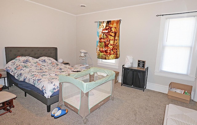 carpeted bedroom with crown molding, baseboards, and multiple windows