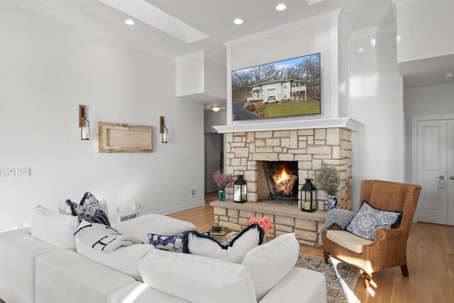 1066 Edinborough Ct, Lake Geneva, WI 53147 - living area featuring crown molding, a stone fireplace, recessed lighting, a skylight, and wood finished floors