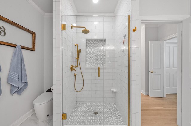 1066 Edinborough Ct, Lake Geneva, WI 53147 - bathroom with baseboards, ornamental molding, toilet, a shower stall, and wood finished floors