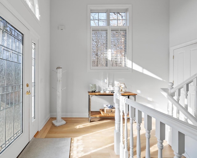1066 Edinborough Ct, Lake Geneva, WI 53147 - entrance foyer featuring stairway, a towering ceiling, baseboards, and wood finished floors