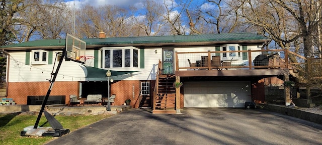 30847 Sun Ct, Burlington, WI 53105 - view of front of home with a garage, brick siding, aphalt driveway, and stairway