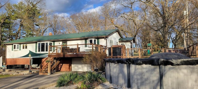 30847 Sun Ct, Burlington, WI 53105 - back of property featuring a covered pool, stairway, aphalt driveway, a garage, and a wooden deck