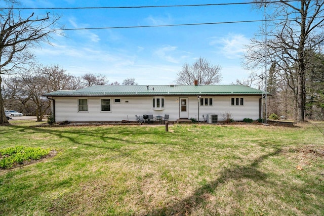 30847 Sun Ct, Burlington, WI 53105 - back of property with metal roof, a yard, entry steps, and central AC